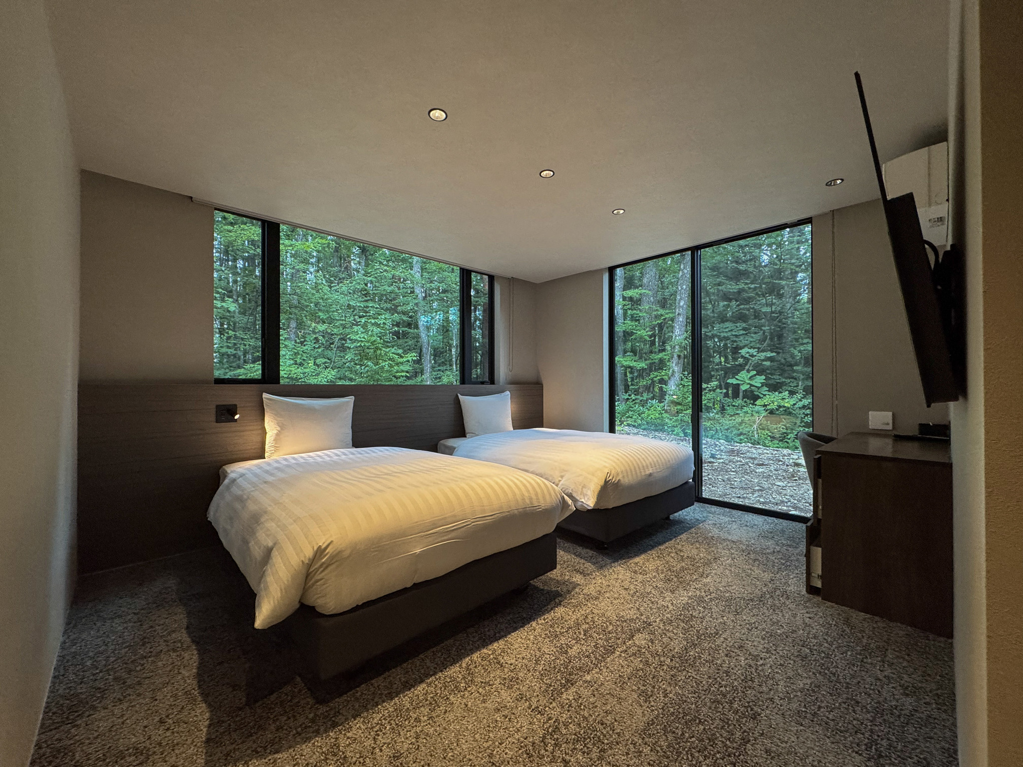 Bedroom 1 with two semi-double beds and forest views